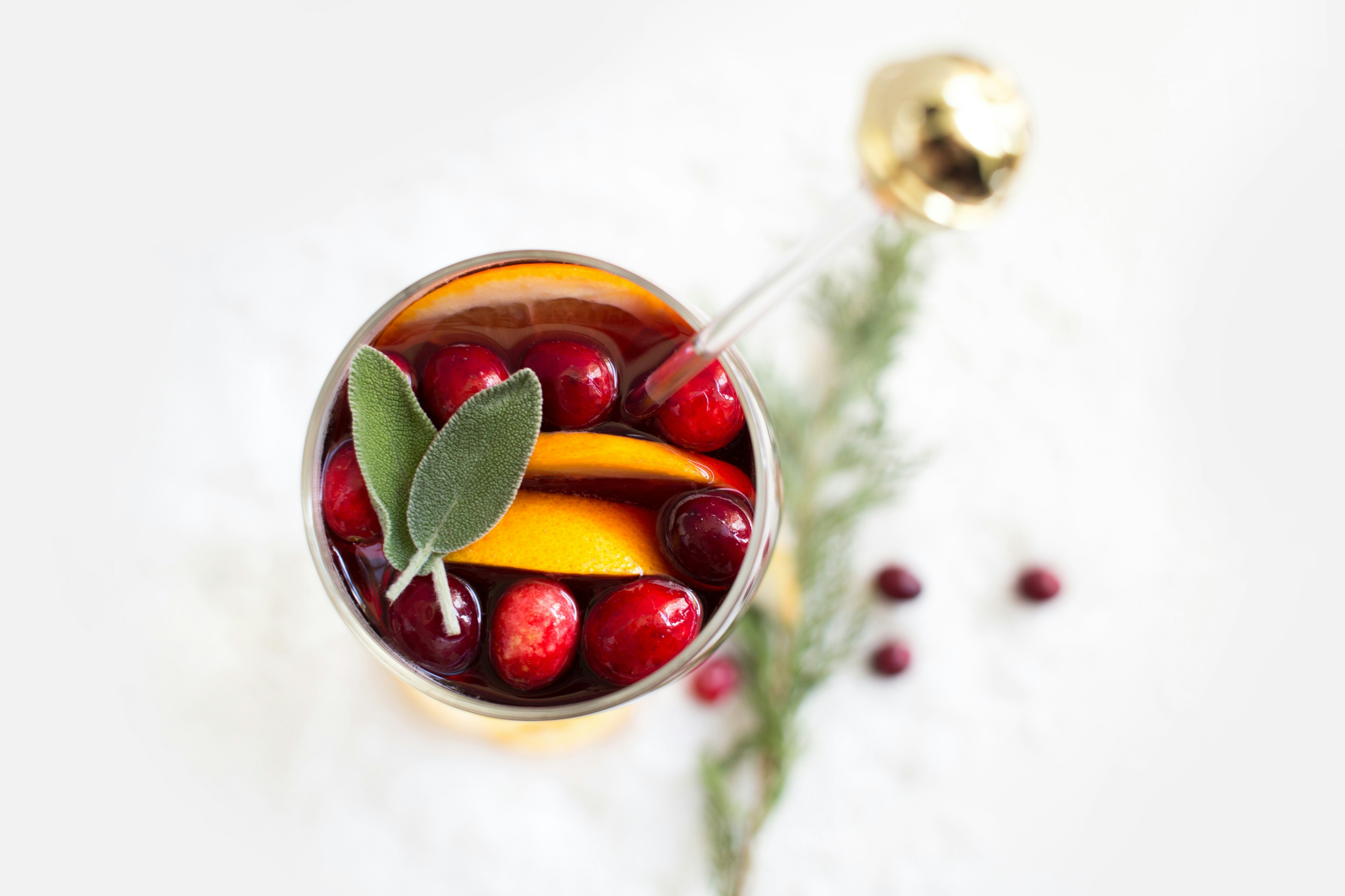 olives and orange fruit slices in cup