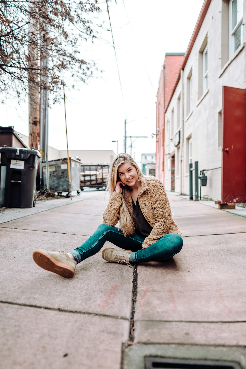 woman sitting on sidewalk