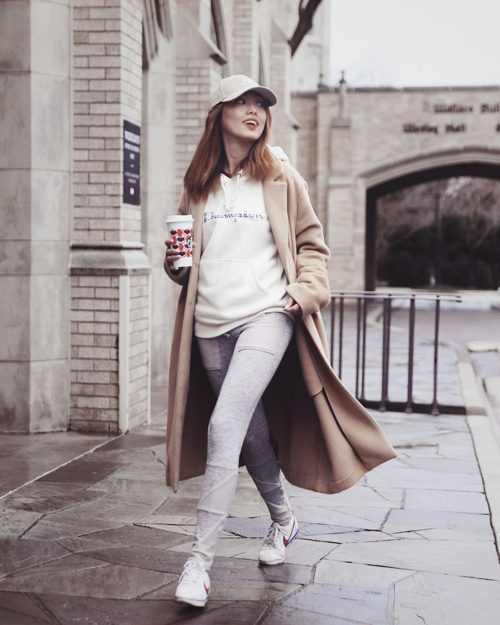 woman holding white plastic cup