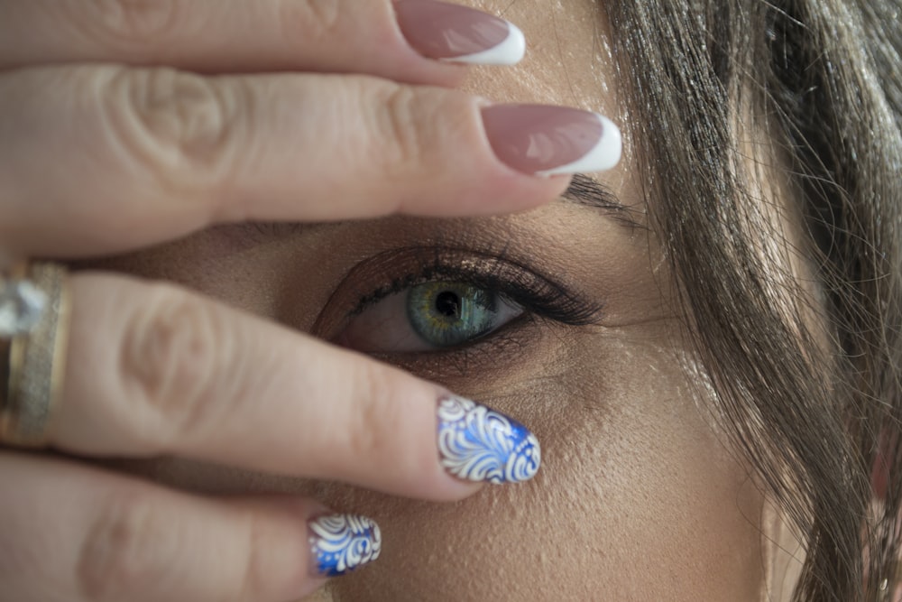 woman covering her right eye while showing her left eye