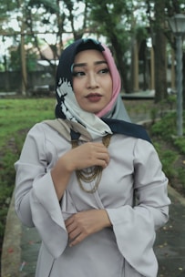 A model wearing a colorful scarf outdoors in natural light.