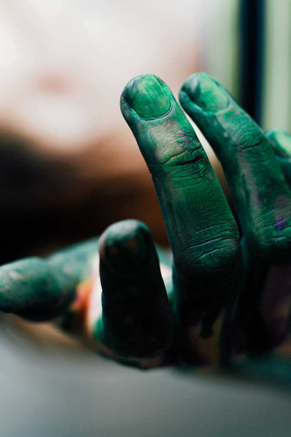 human hand with green paint