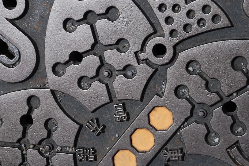 a close up of a metal surface with holes in it