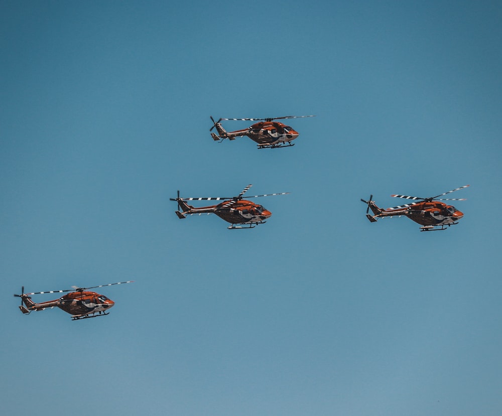 four helicopters at the sky