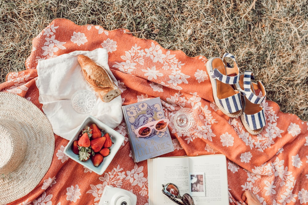 top angle photography of strawberries beside book