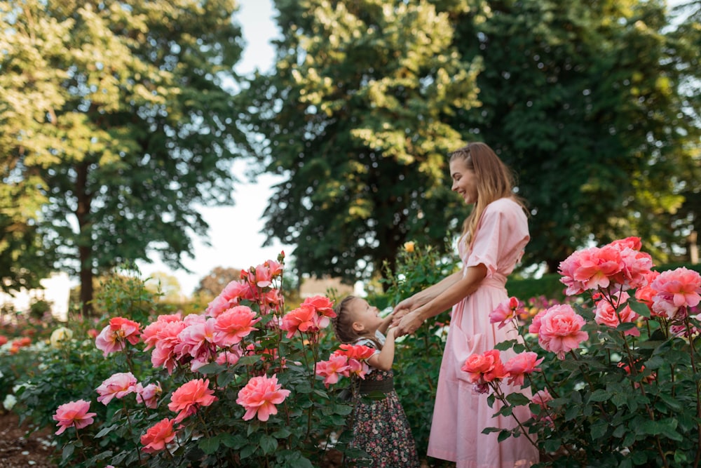 woman holding hands of girl