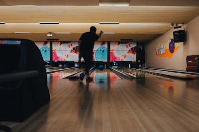 An adult player perfecting bowling form during an early morning practice at the academy.