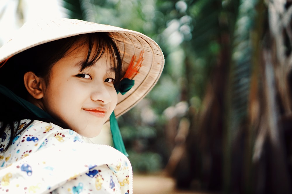 woman in white and multicolored top and hat