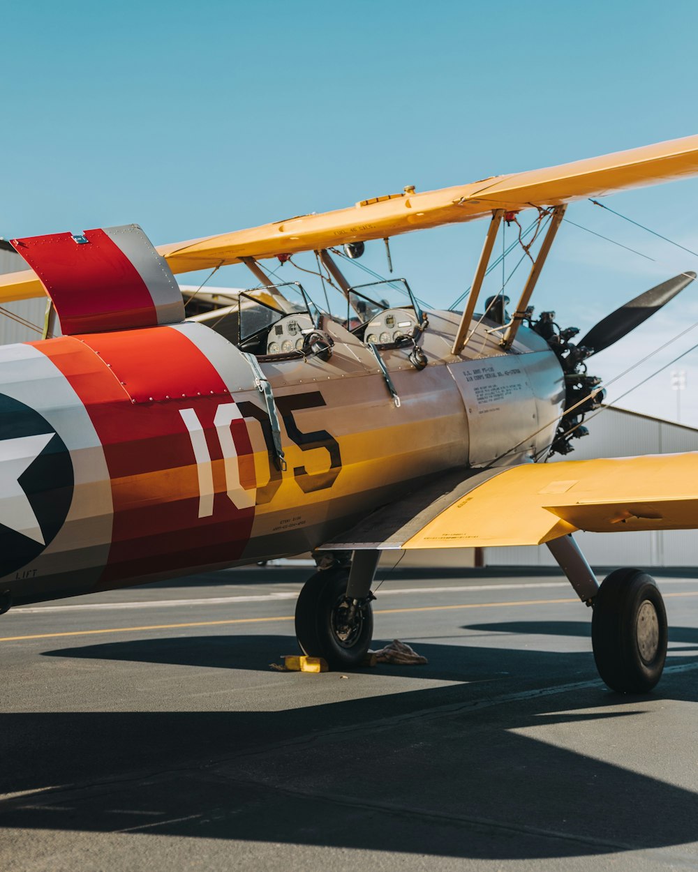 yellow, red, and white biplane