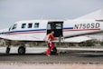 man standing beside white aircraft