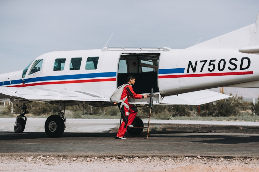 man standing beside white aircraft