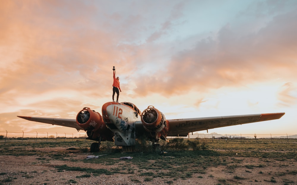 selective focus photography of person standing on airplane