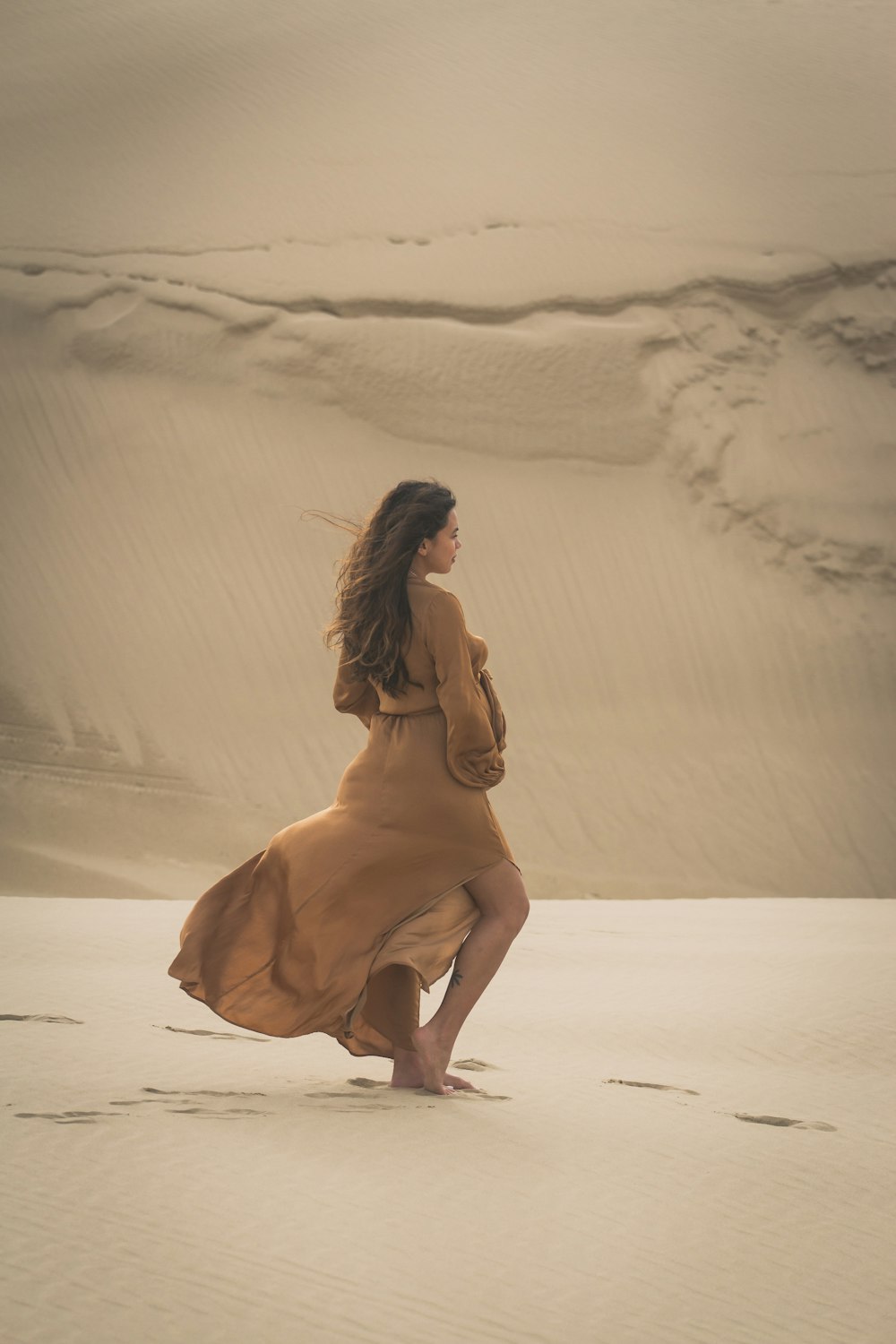 낮 동안 모래 위를 걷는 여자