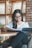 A person reading a scientific journal in a cozy study room.