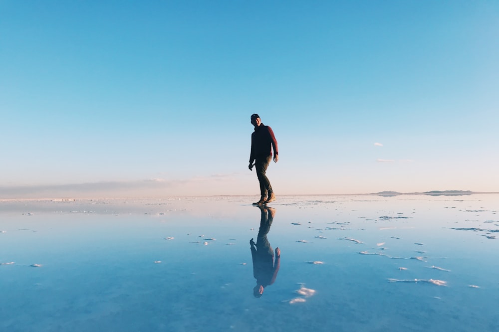 man walking on wet floor during day