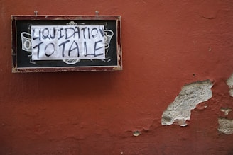 rectangular black and brown liquidation totale signage