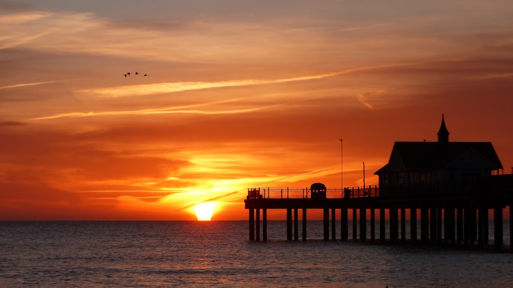 house on wooden dock during golden hour