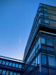 Modern corporate office building with a clear sky, symbolizing global business connections.