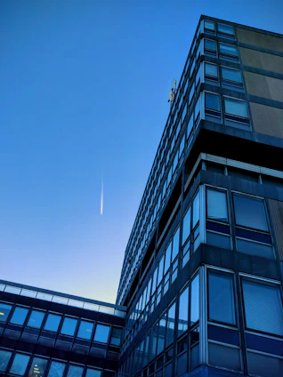 Modern corporate office building with a clear sky, symbolizing global business connections.
