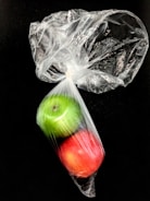 Close-up of biodegradable polypropylene bags with fresh fruits inside.