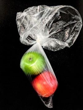 Close-up of biodegradable polypropylene bags with fresh fruits inside.