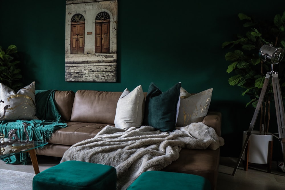 brown leather padded sofa with throw pillows inside house