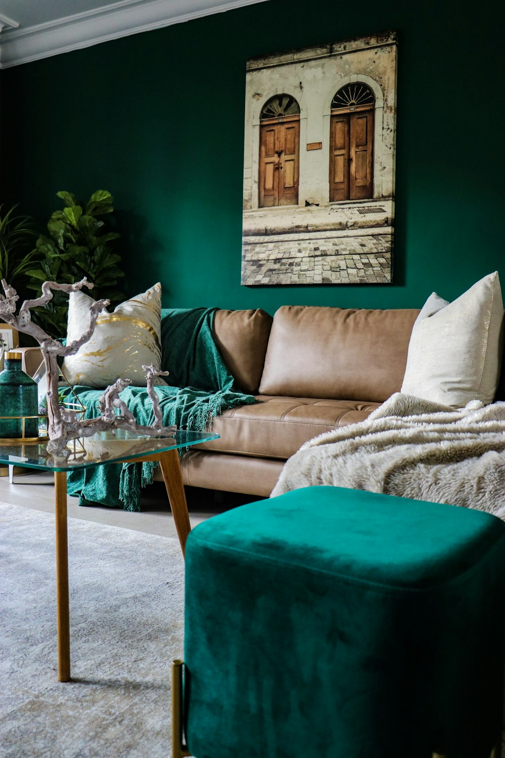beige leather couch and green ottoman