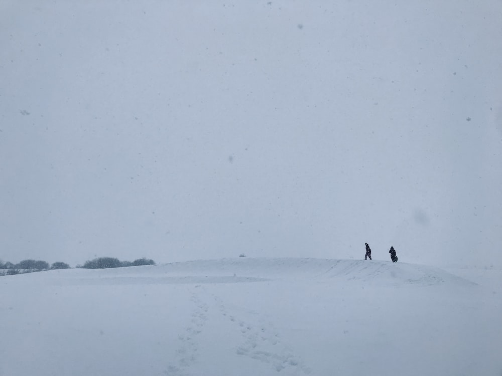 silhouette of two people on snowy land