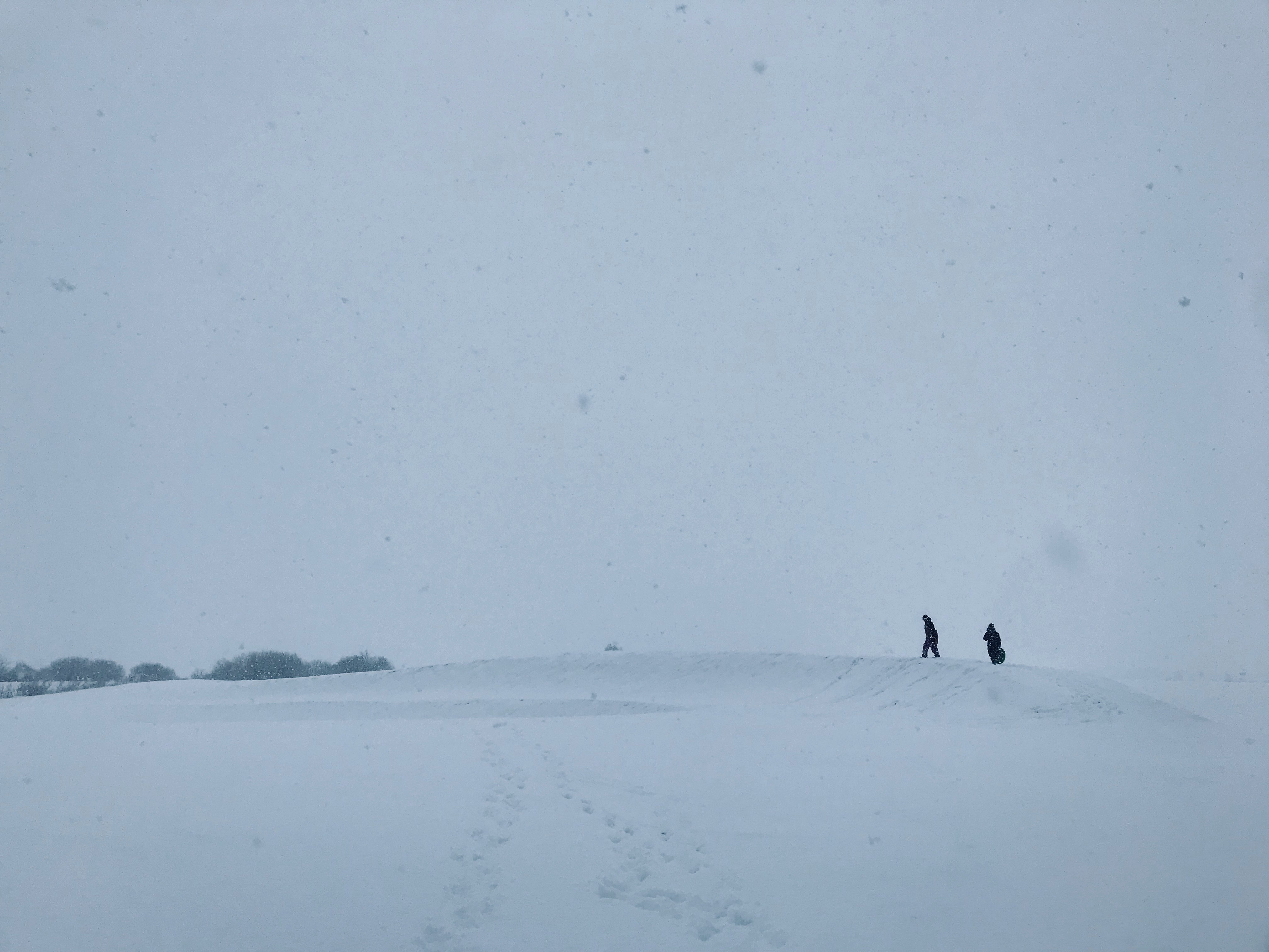 silhouette of two people on snowy land