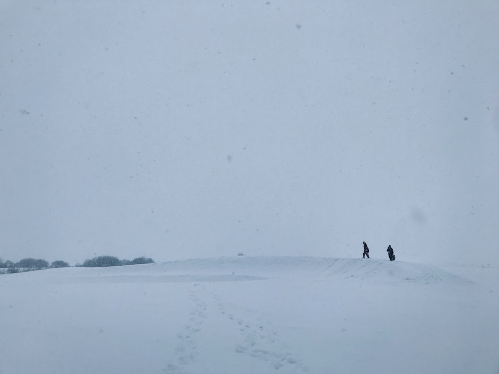 silhouette of two people on snowy land