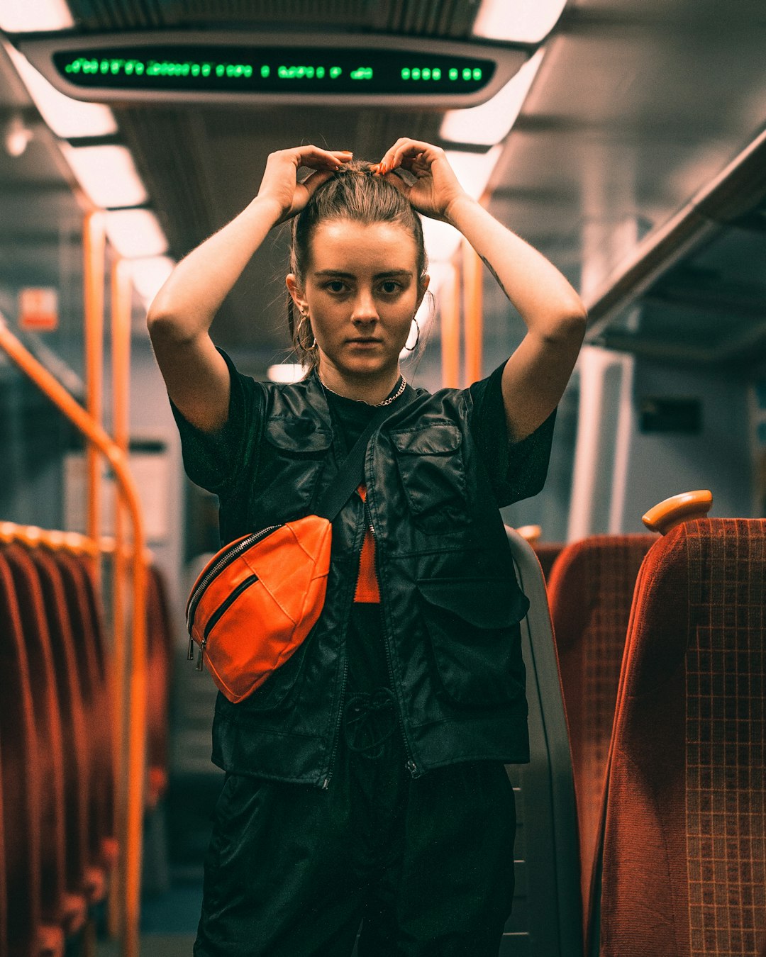 woman in black top holding her hair