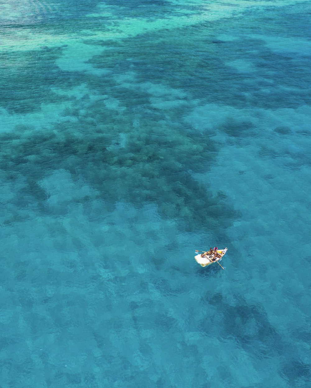 boat sailing on calm body of water