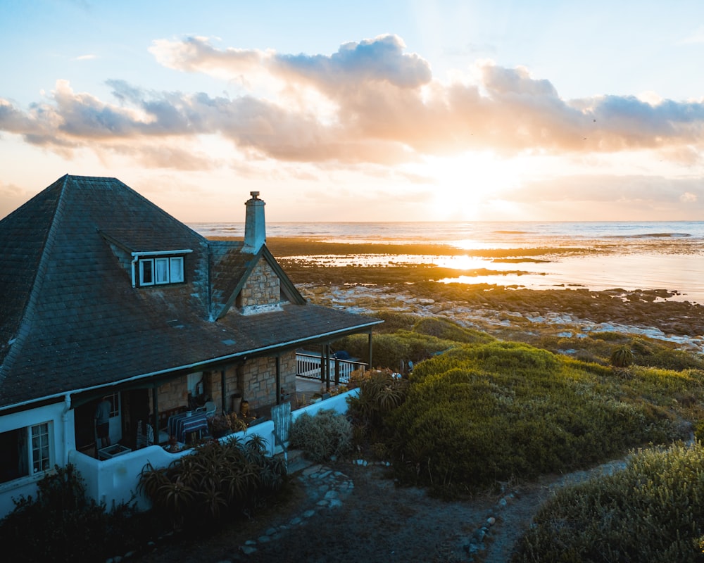 aerial photo of house near calm body of water