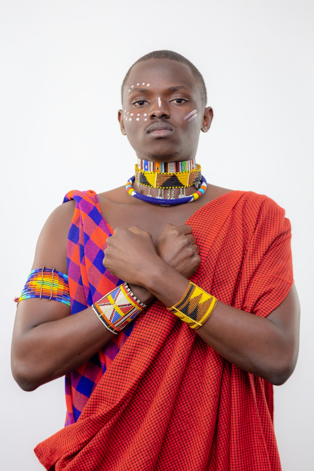 man standing wearing red and orange knit apparel]