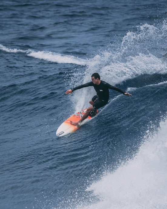 man surfing on sea waves