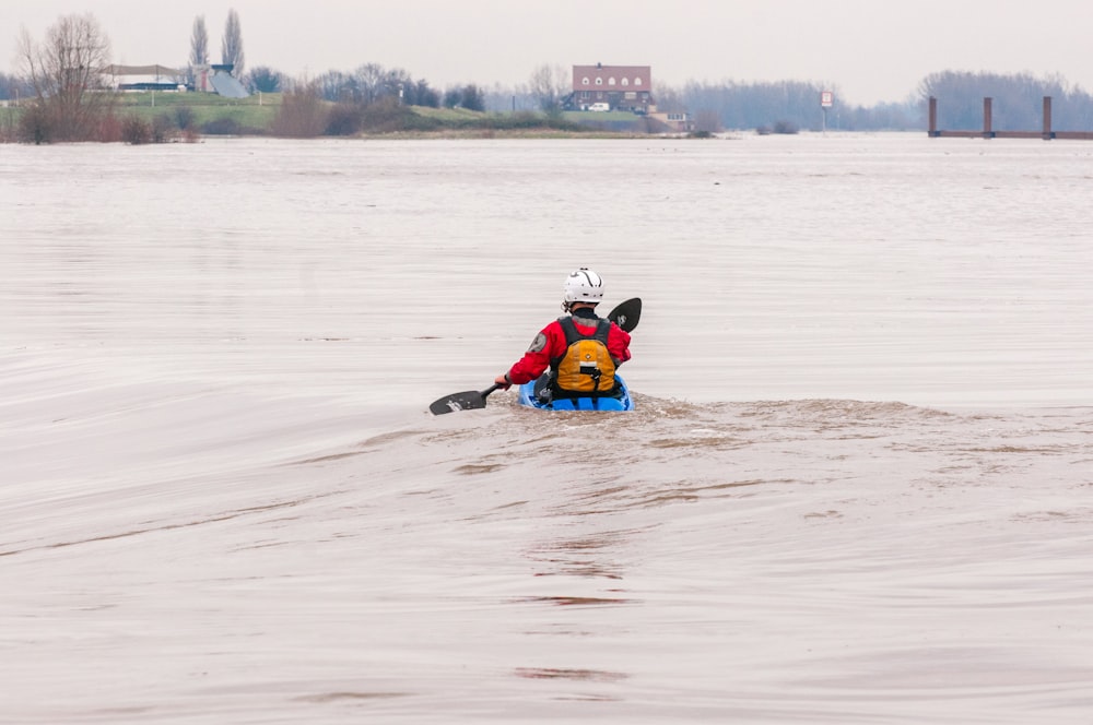 man in red jacket kayaking