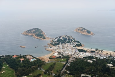 Aerial view of Bodrum coastline with villas and green landscapes.