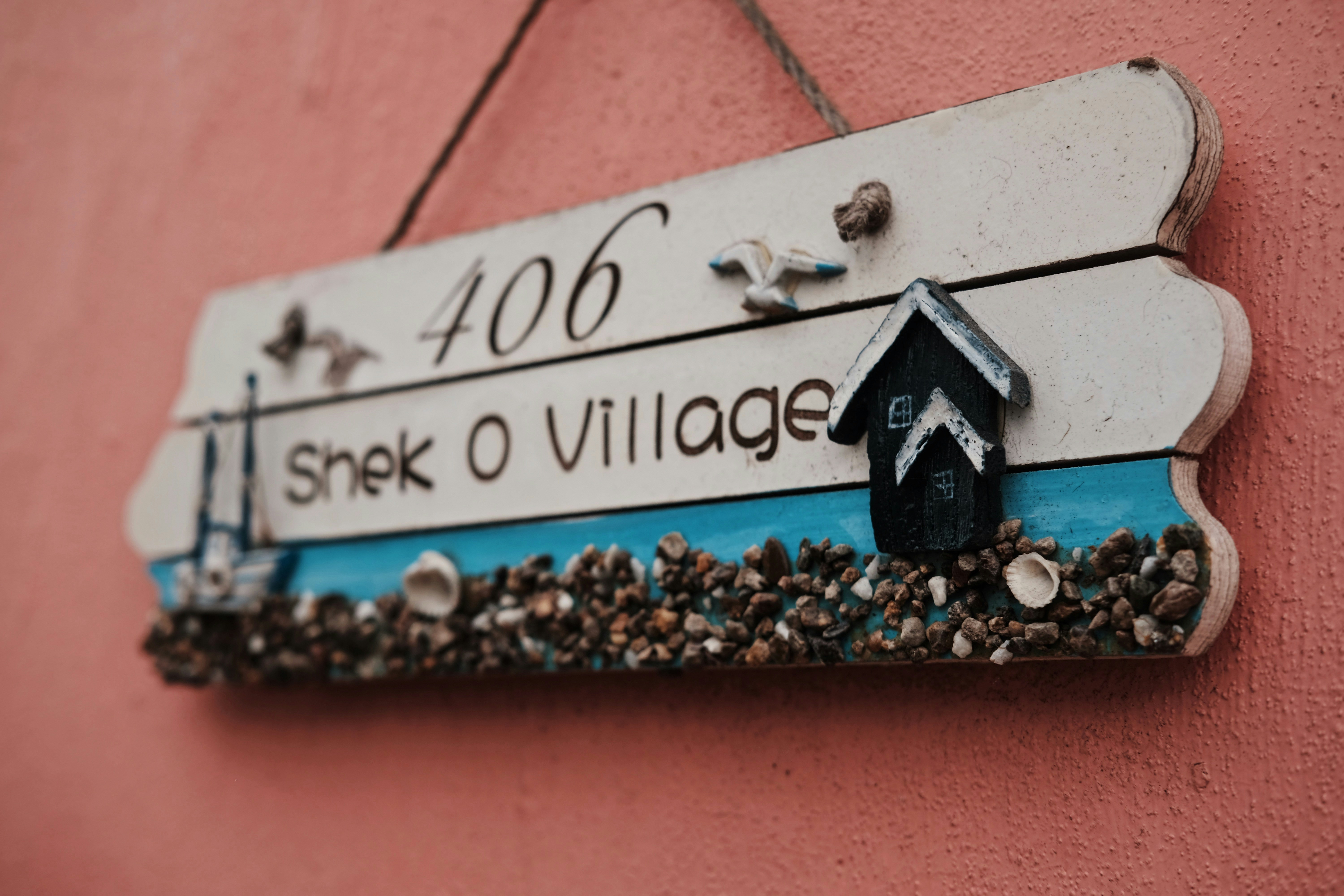 406 Shek O Village wall signage on pink wall