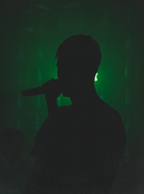 silhouette of person holding microphone