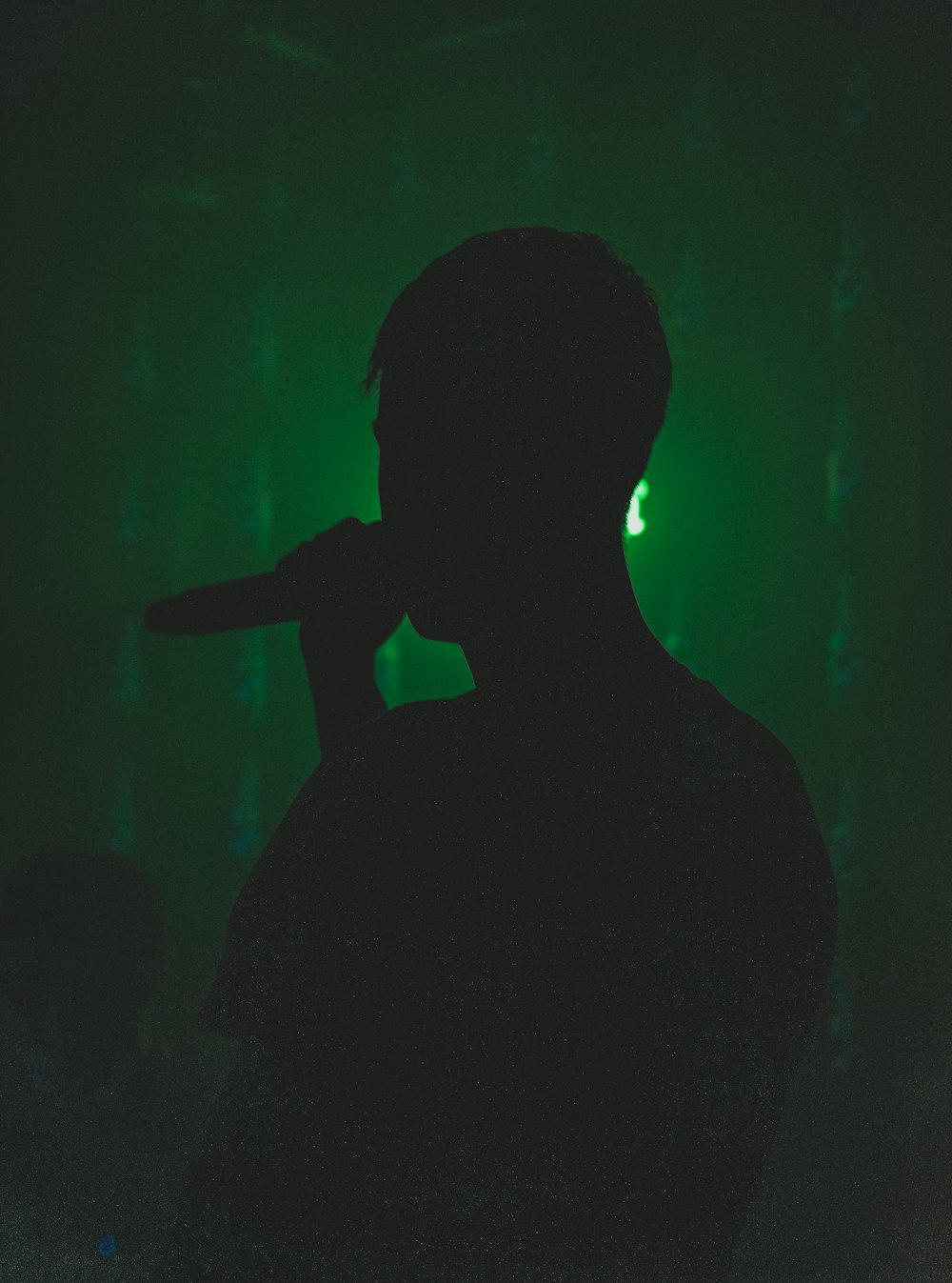 silhouette of person holding microphone