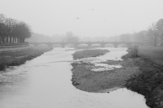A misty old bridge over a quiet river at Ravens Ferry, shrouded in twilight shadows.