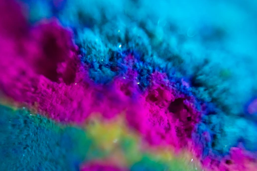 A vibrant close-up of a mixed media artwork blending paint and photography.