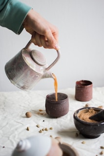 person pouring cocojoe into cup 