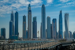 blue concrete city buildings under white and blue cloudy sky
