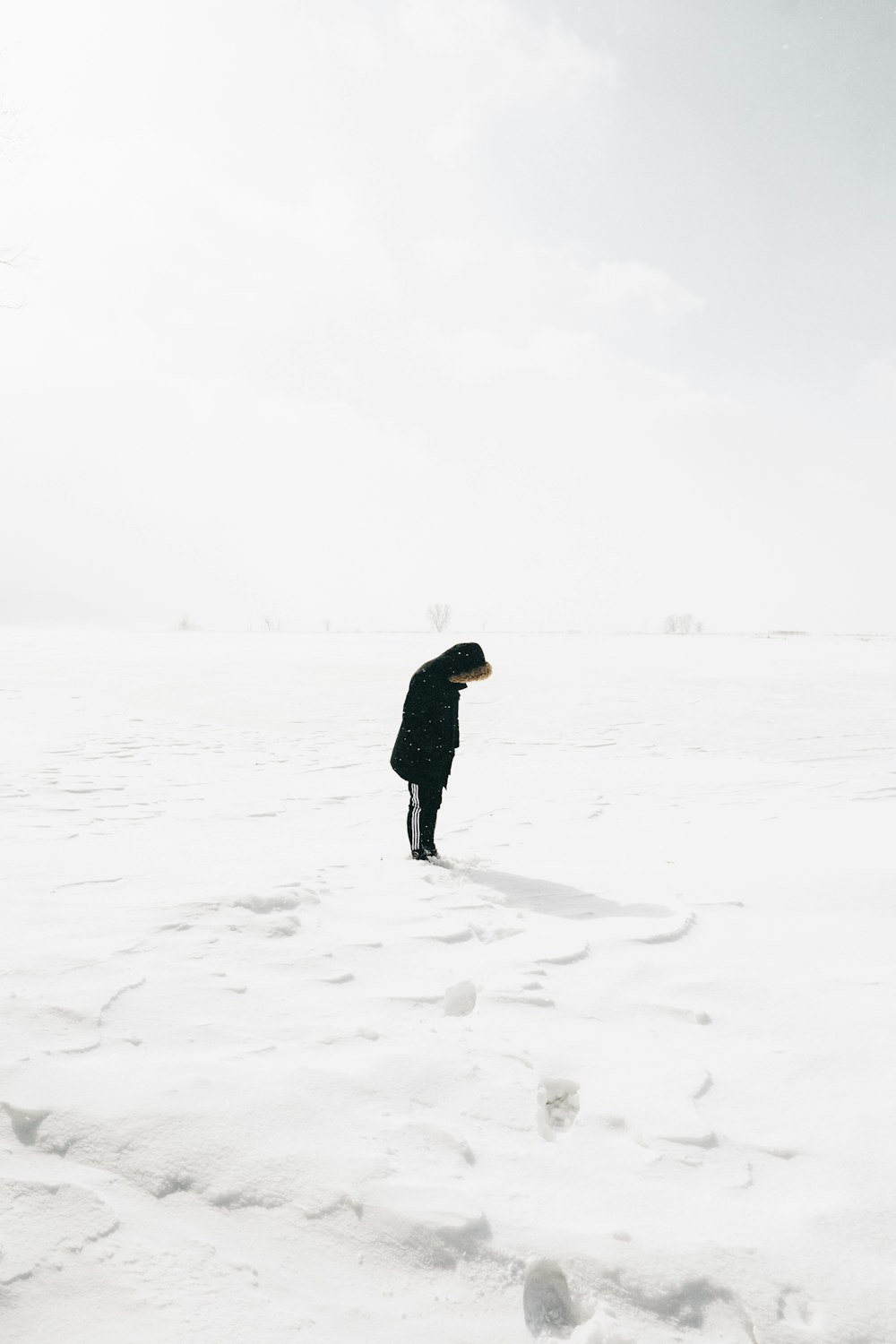 person standing on snow covered field