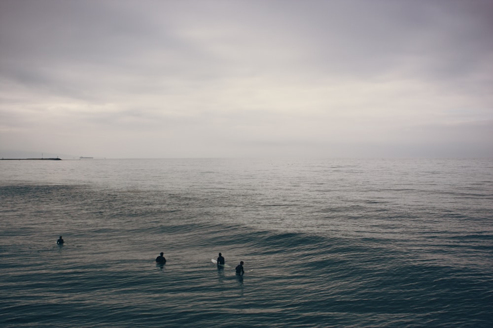 four person on water during daytime