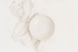Close-up of a smooth, matte white ceramic bowl with sharp edges on a pure white background.