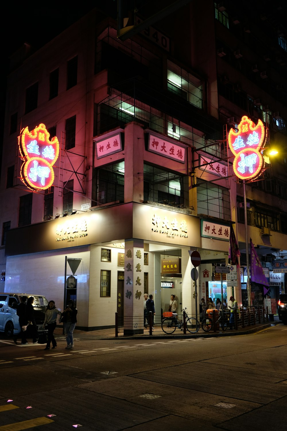 people walking on sidewalk during nighttime