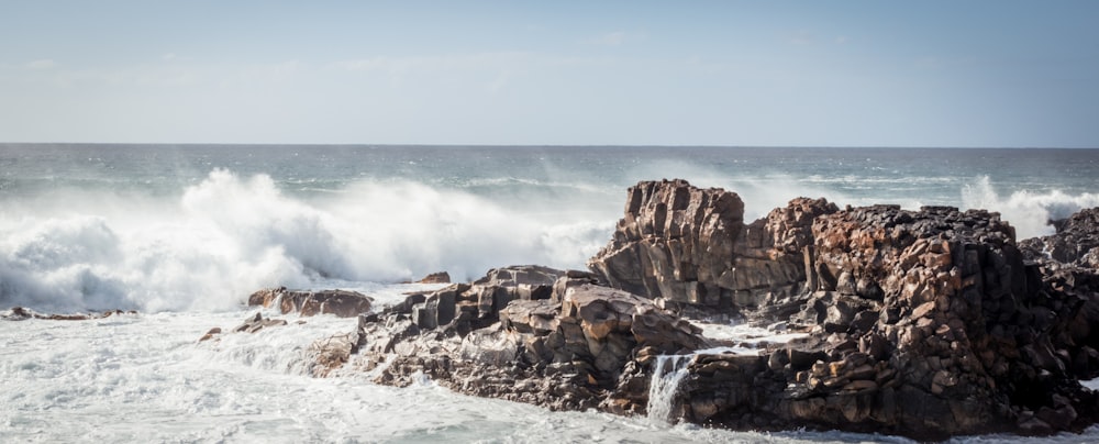 rocky island beside beach