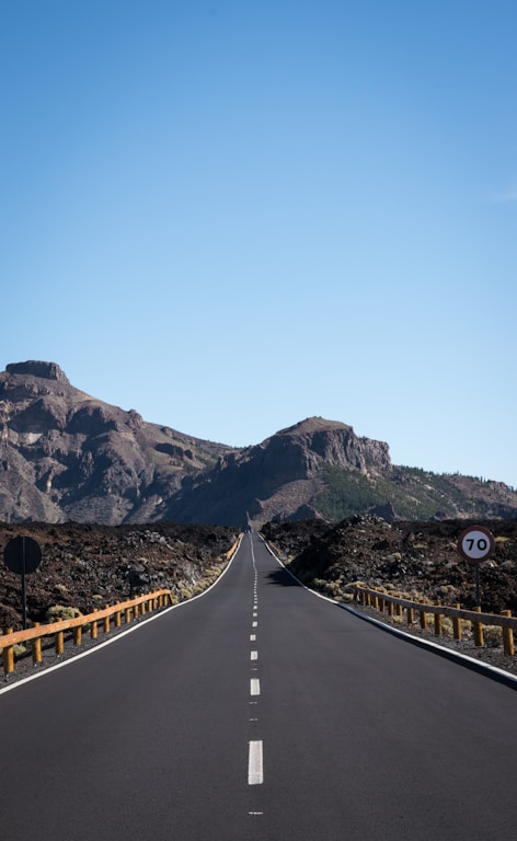 straight asphalt road with mountain background